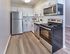 Renovated kitchen with stainless steel appliances at Village Square Apartments.
