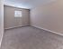 Spacious bedroom with carpet flooring at Village Square Apartments.