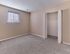 Spacious bedroom with soft carpet flooring and a large closet at Village Square Apartments.