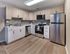 Modern kitchen with stainless steel appliances and sleek cabinetry at Audubon Arms Apartments in Audubon, NJ