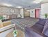 Stylish and welcoming lobby with modern seating and patterned carpet at Audubon Arms Apartments in Audubon, NJ