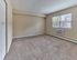 Bright bedroom with large window, plush carpet, and neutral tones at 42 West Apartments in Merchantville, NJ