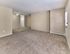 Spacious carpeted living room with neutral tones and natural light at 42 West Apartments in Merchantville, NJ