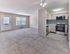 Open-concept living room and modern kitchen with stainless steel appliances at 42 West Apartments in Merchantville, NJ