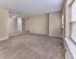 Bright and spacious living room with plush carpet and natural light at 42 West Apartments in Merchantville, NJ