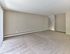 Large carpeted living room with neutral tones and natural light at Maple Terrace Apartments in Maple Shade, NJ