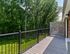 Private balcony with wooded view and modern railing at Maple Terrace Apartments in Maple Shade, NJ