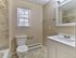 Renovated bathroom with white vanity, modern fixtures, and tiled shower at Maple Terrace Apartments in Maple Shade, NJ