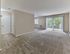 Large carpeted living room with sliding glass doors to private balcony at Maple Terrace Apartments in Maple Shade, NJ