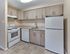 Modern kitchen with white appliances and light wood cabinets at Maple Terrace Apartments in Maple Shade, NJ