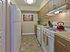 Renovated galley kitchen with wood cabinetry, gas range, tile backsplash, and modern finishes at Haynes Run Apartments in Medford, NJ