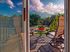 Private balcony with patio seating and scenic view of trees and sky at Haynes Run Apartments in Medford, NJ