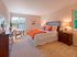 Bright and spacious bedroom with natural light and plush carpeting at Haynes Run Apartments in Medford, NJ