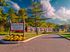Front entrance and community sign at Haynes Run Apartments in Medford, NJ with landscaped flowers and well-maintained apartment buildings in the background.