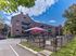 Fenced dog park with shaded seating area at Wessex House Apartments in Wayne, PA