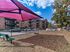 Fenced dog park with shaded seating and play area at Wessex House Apartments in Wayne, PA