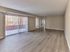 Spacious living room with wood-style flooring and sliding glass doors leading to a private balcony in a 2 bedroom, 2 bathroom apartment at North Crossing in Willow Grove, Pennsylvania.