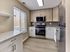 Modern kitchen with stainless steel appliances, quartz-style countertops, and tile backsplash in a 2 bedroom, 2 bathroom apartment at North Crossing in Willow Grove, PA.