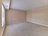 Spacious carpeted bedroom with large window in a 2 bedroom, 2 bathroom apartment at North Crossing in Willow Grove, PA.