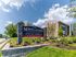 Exterior view of North Crossing Apartments in Willow Grove, Pennsylvania, featuring landscaped green lawns, newly renovated brick architecture, and the new community entrance sign displaying the address 3625.