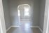 hallway with arch doorway into kitchen