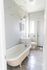 full bathroom with window, tiled floor, and white cabinets under sink