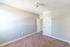 carpeted bedroom with window and ceiling light