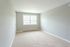 carpeted room with large windows