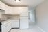 modern kitchen with white cabinets and included fridge and stove