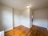 apartment den with hardwood floor and overhead light