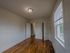 apartment with hardwood floor, window, ceiling light fixture, closet