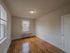 apartment with hardwood floor, windows, ceiling light fixture, closet, radiator