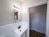 bright bathroom, view into hallway towards closet, vanity sink