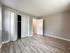 bedroom with wood floor, closet, door leading to hallway