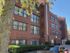Red brick 4 story apartment building with dark windows