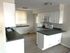 Kitchen with white cabinets and dark counter tops
