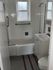 Bathroom with white tub and vanity