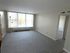 Large carpeted living room connected to the kitchen