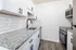 Renovated kitchen with granite countertops and stainless steel appliances