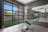 Modern indoor/outdoor fitness center featuring a variety of exercise equipment including treadmills, weights, rowing machines, and other state-of-the-art equipment.