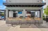 An outdoor tiki bar next to the swimming pool with four chairs and two flat screen TVs, one of many amenities at The Ave in Clintonville, Ohio.