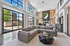 A 24/7 clubhouse with comfortable seating areas, a fireplace, Crimson Cup coffee bar, and large windows offering views of the surrounding landscape.