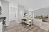 Open-layout living room with ample space for seating, featuring comfortable furniture, and large windows that let in natural light.