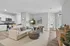 Open-layout living room and kitchen with luxury vinyl wood flooring, and ample space for seating.