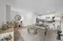 Open-layout living room and kitchen with luxury vinyl wood flooring, and ample space for seating.