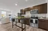 A modern kitchen featuring stainless steel appliances, including a refrigerator, oven, and dishwasher. The kitchen also showcases soft-close cabinetry, granite countertops, and overhead lighting.