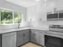 Sleek modern kitchen with stainless steel appliances, white and gray cabinetry, and a large window providing natural light. Explore pet-friendly studio, one-, and two-bedroom apartments in Cincinnati, OH. The Alcove offers upscale living with premium amenities near downtown. apartments for rent in Cincinnati OH, Cincinnati luxury apartments, pet-friendly apartments in Cincinnati, downtown Cincinnati apartments, one bedroom apartments Cincinnati, The Alcove Apartments Cincinnati