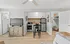 Chic studio apartment interior with an open kitchen, modern appliances, and cozy living space.