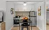 Contemporary compact kitchen with sleek appliances, modern cabinetry, and stylish decor.