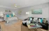 Elegant bedroom with cozy bedding and modern living area featuring a stylish sofa and artwork.